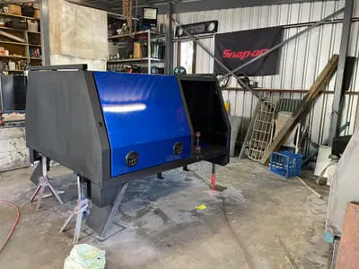 Custom blue ute canopy in workshop